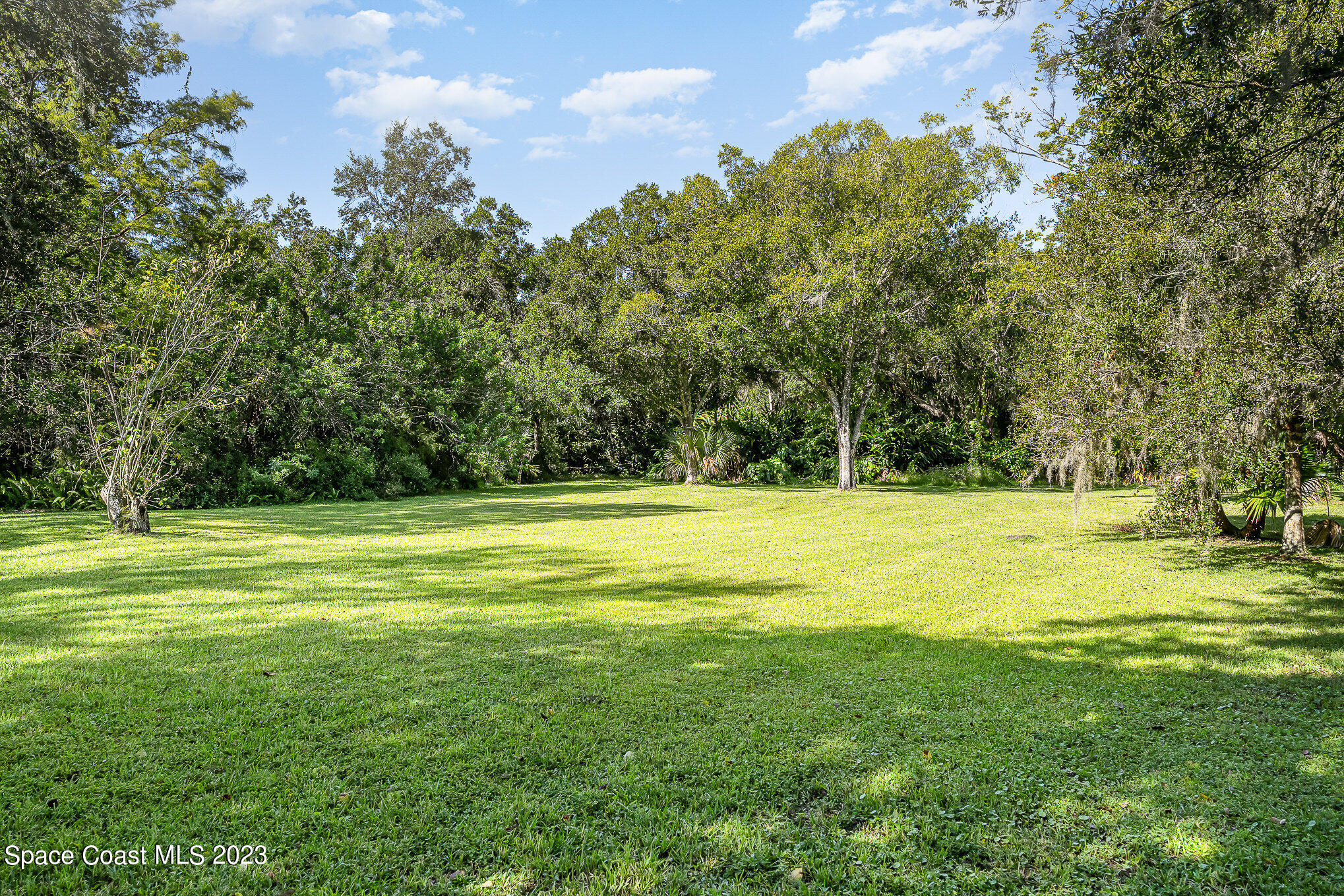 3395 Turtle Mound Road Melbourne, FL 32934 - Photo 12 of 48 a view of a swimming pool with an outdoor space and seating area