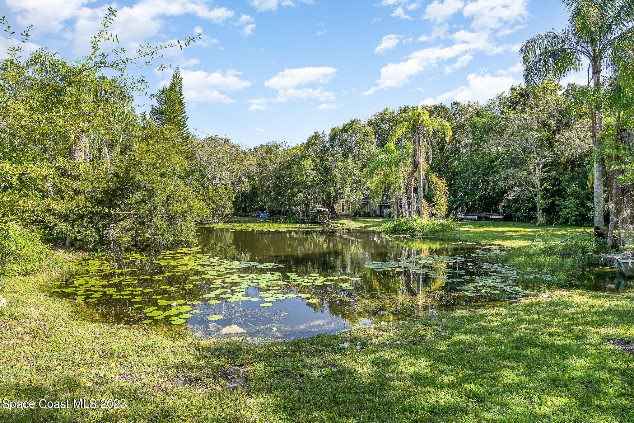 3395 Turtle Mound Road Melbourne, FL 32934 - Photo 13 of 48 a view of a lake from a yard