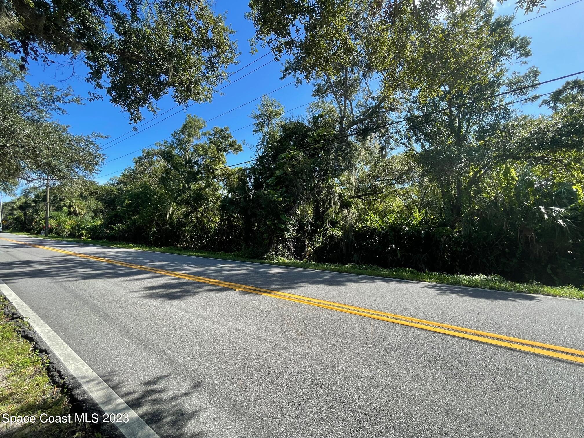 3395 Turtle Mound Road Melbourne, FL 32934 - Photo 17 of 48 a view of a swimming pool with an outdoor space and seating area