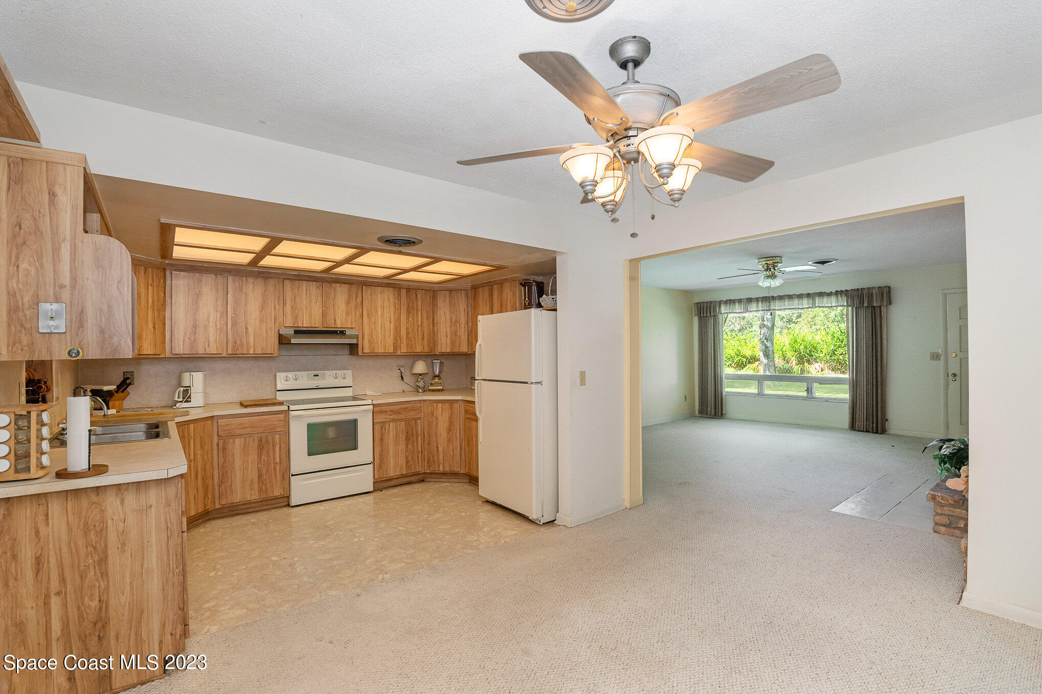 3395 Turtle Mound Road Melbourne, FL 32934 - Photo 26 of 48 a open kitchen with a stove a refrigerator and a stove top oven