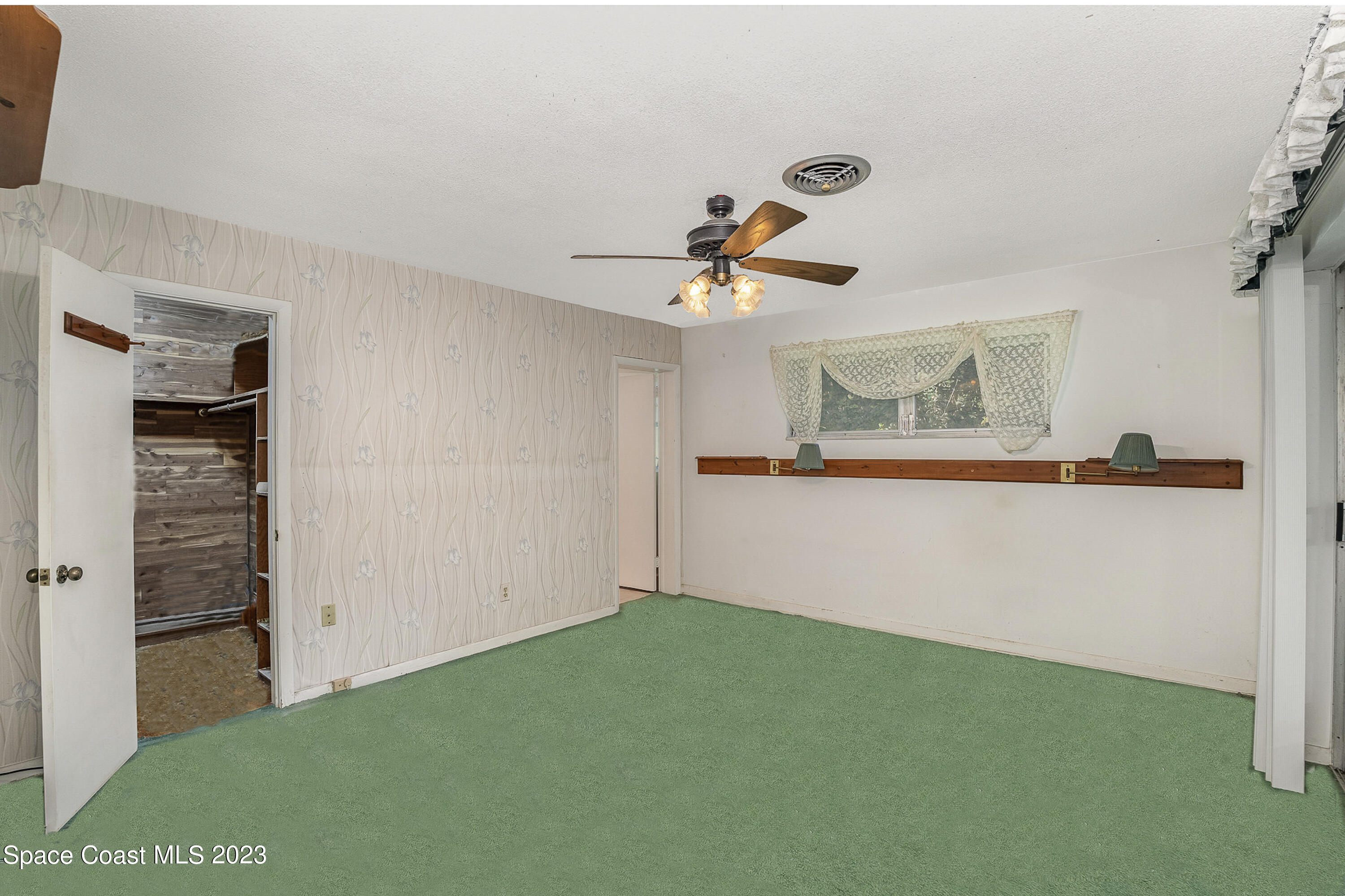 3395 Turtle Mound Road Melbourne, FL 32934 - Photo 29 of 48 a view of a livingroom with a ceiling fan
