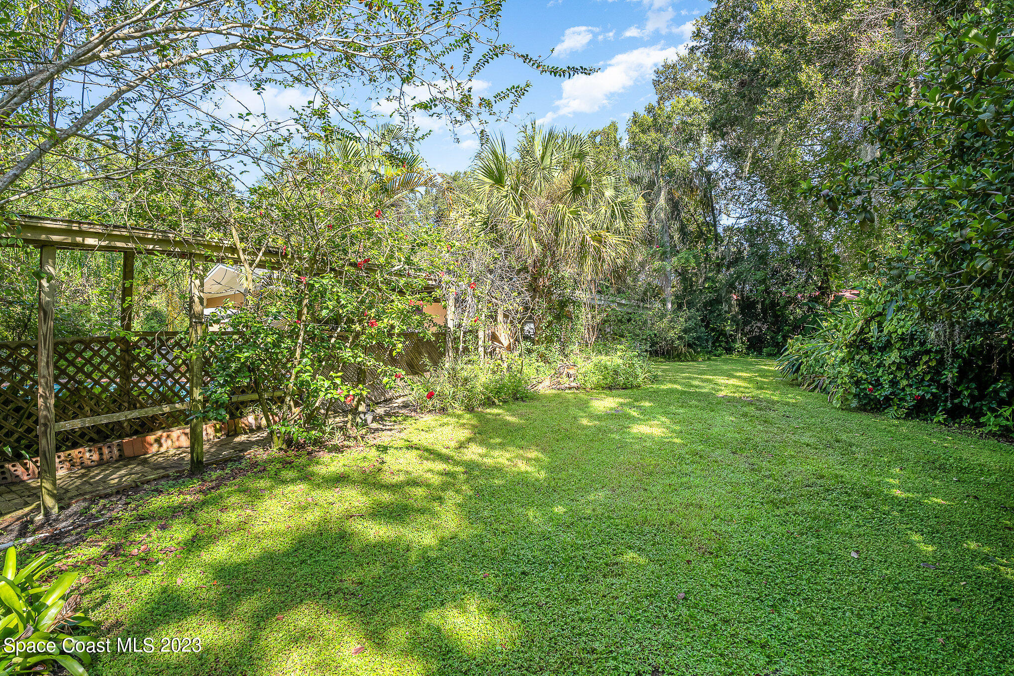 3395 Turtle Mound Road Melbourne, FL 32934 - Photo 37 of 48 a view of yard with green space and bench