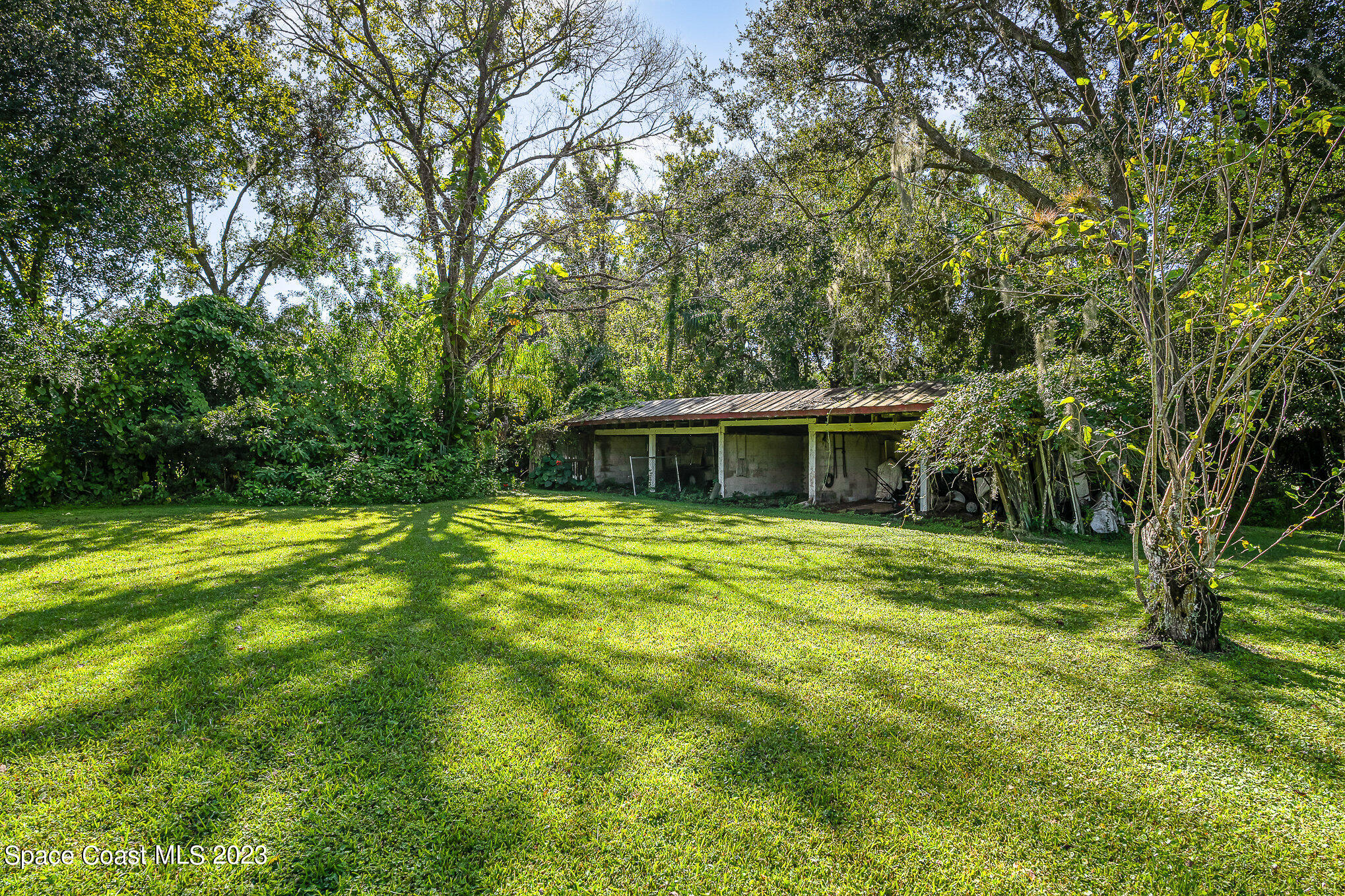 3395 Turtle Mound Road Melbourne, FL 32934 - Photo 42 of 48 a view of a house with a yard