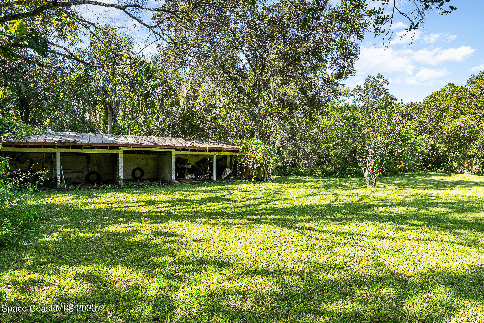 3395 Turtle Mound Road Melbourne, FL 32934 - Photo 43 of 48 a front view of house with yard and green space