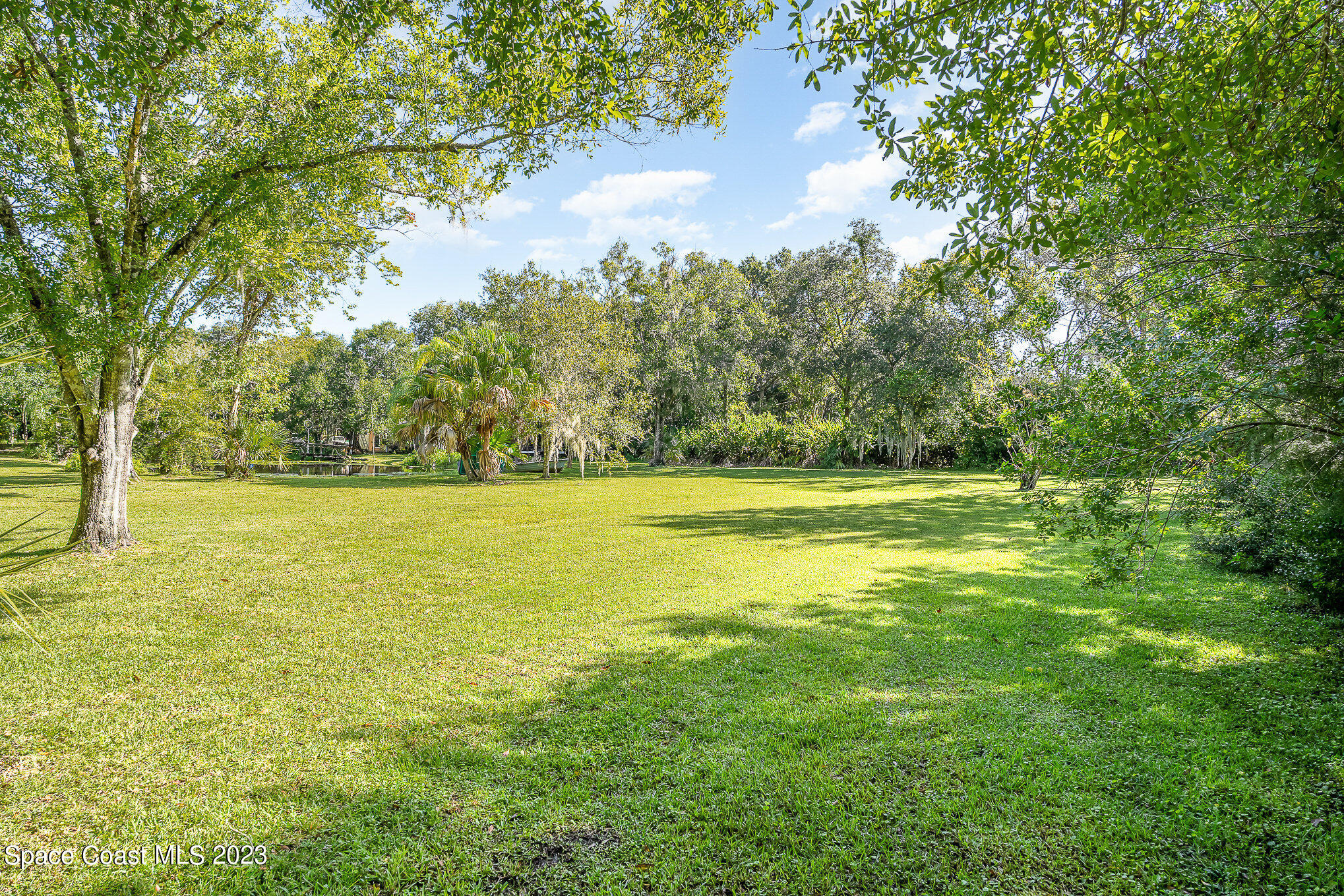3395 Turtle Mound Road Melbourne, FL 32934 - Photo 44 of 48 a view of a yard with a tree