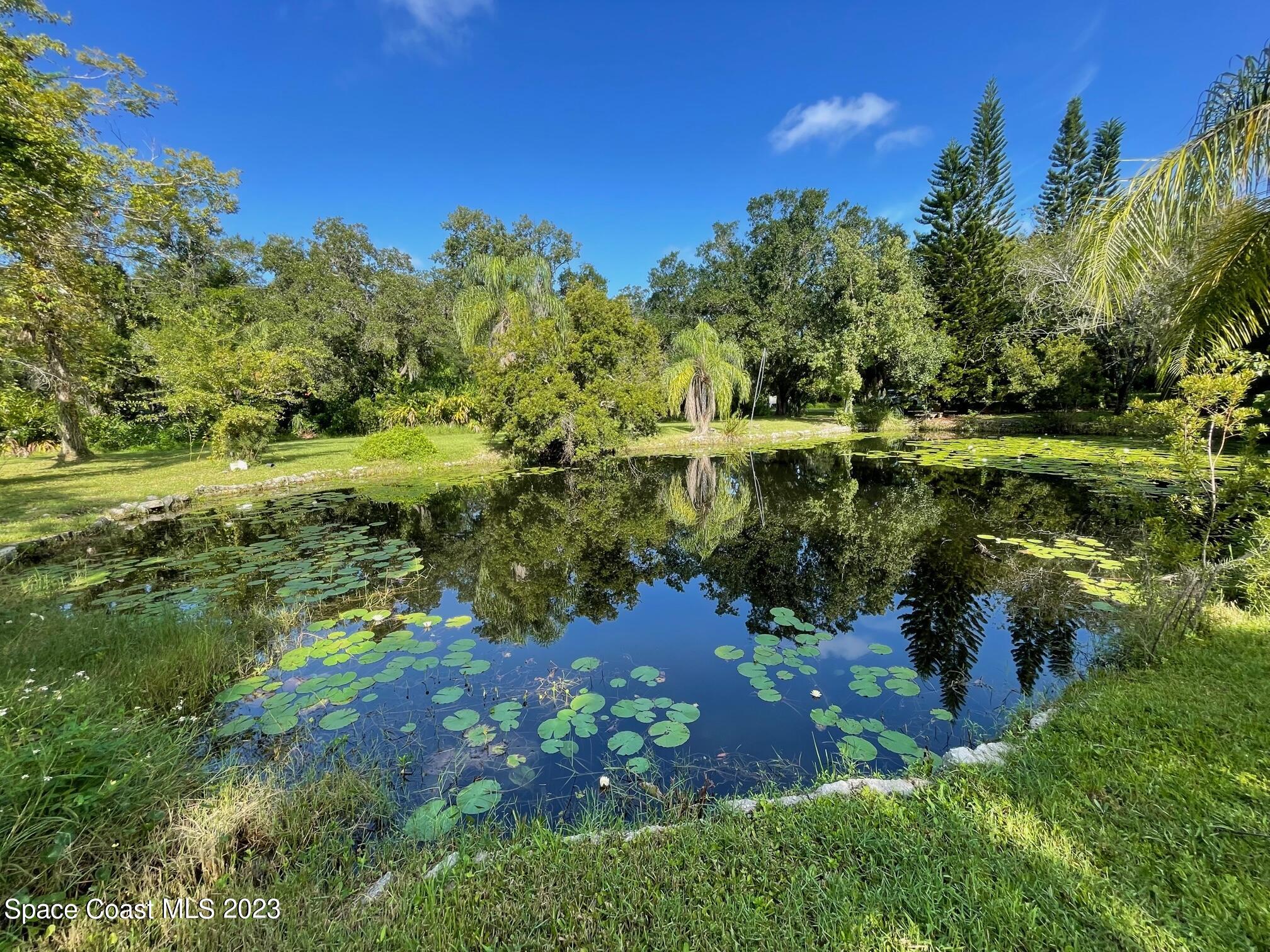 3395 Turtle Mound Road Melbourne, FL 32934 - Photo 47 of 48 a view of a lake with a yard