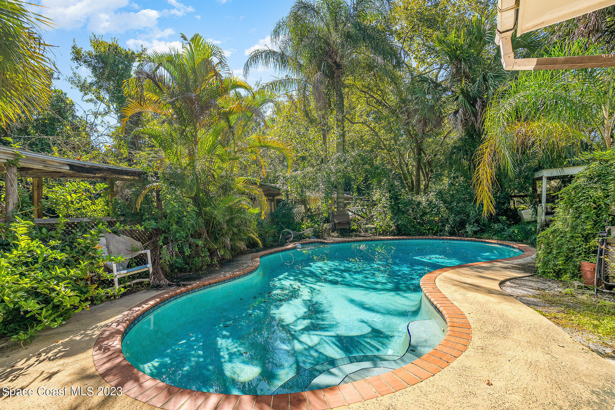 3395 Turtle Mound Road Melbourne, FL 32934 - Photo 6 of 48 a view of a swimming pool with a patio