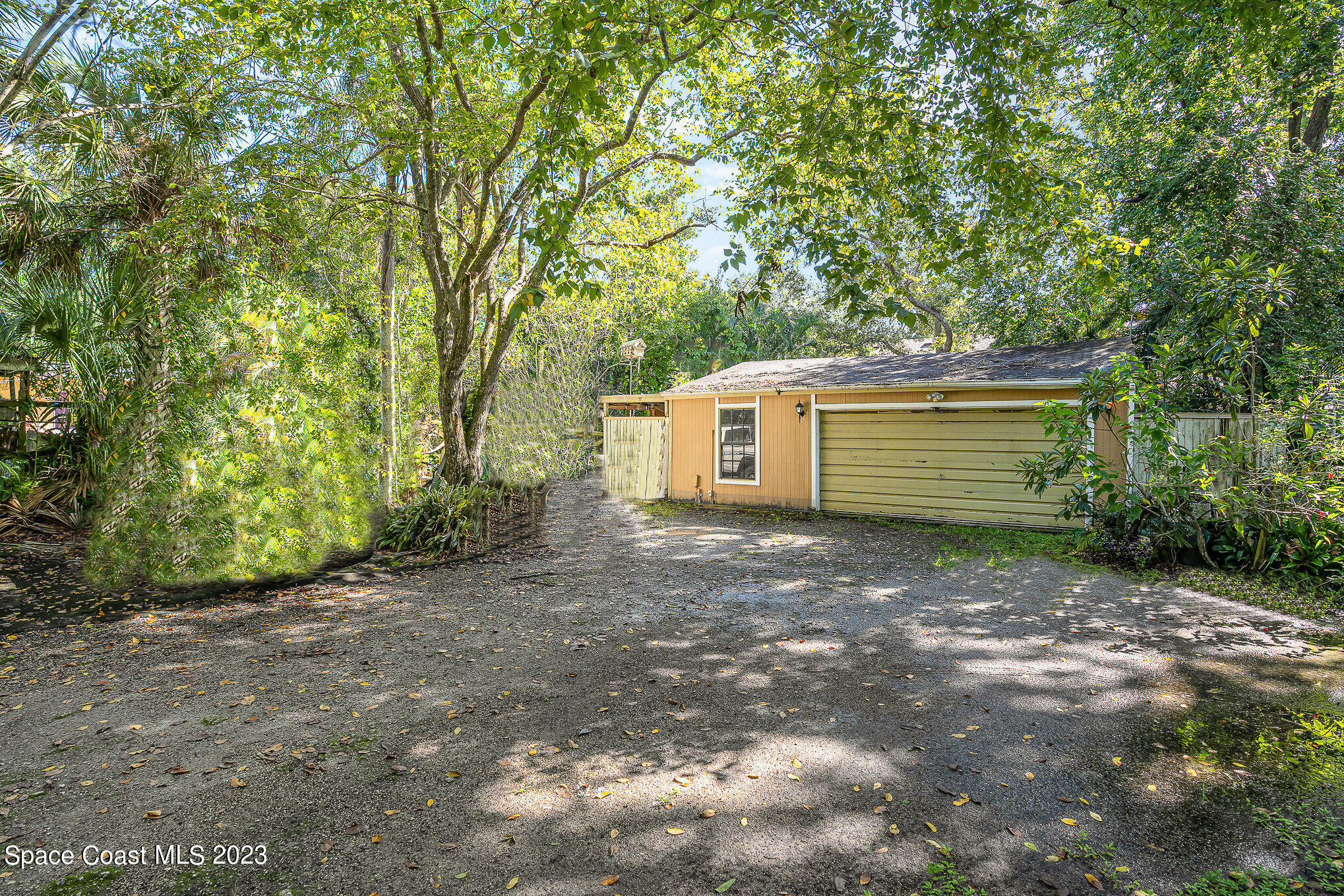 3395 Turtle Mound Road Melbourne, FL 32934 - Photo 8 of 48 a view of a backyard with large trees