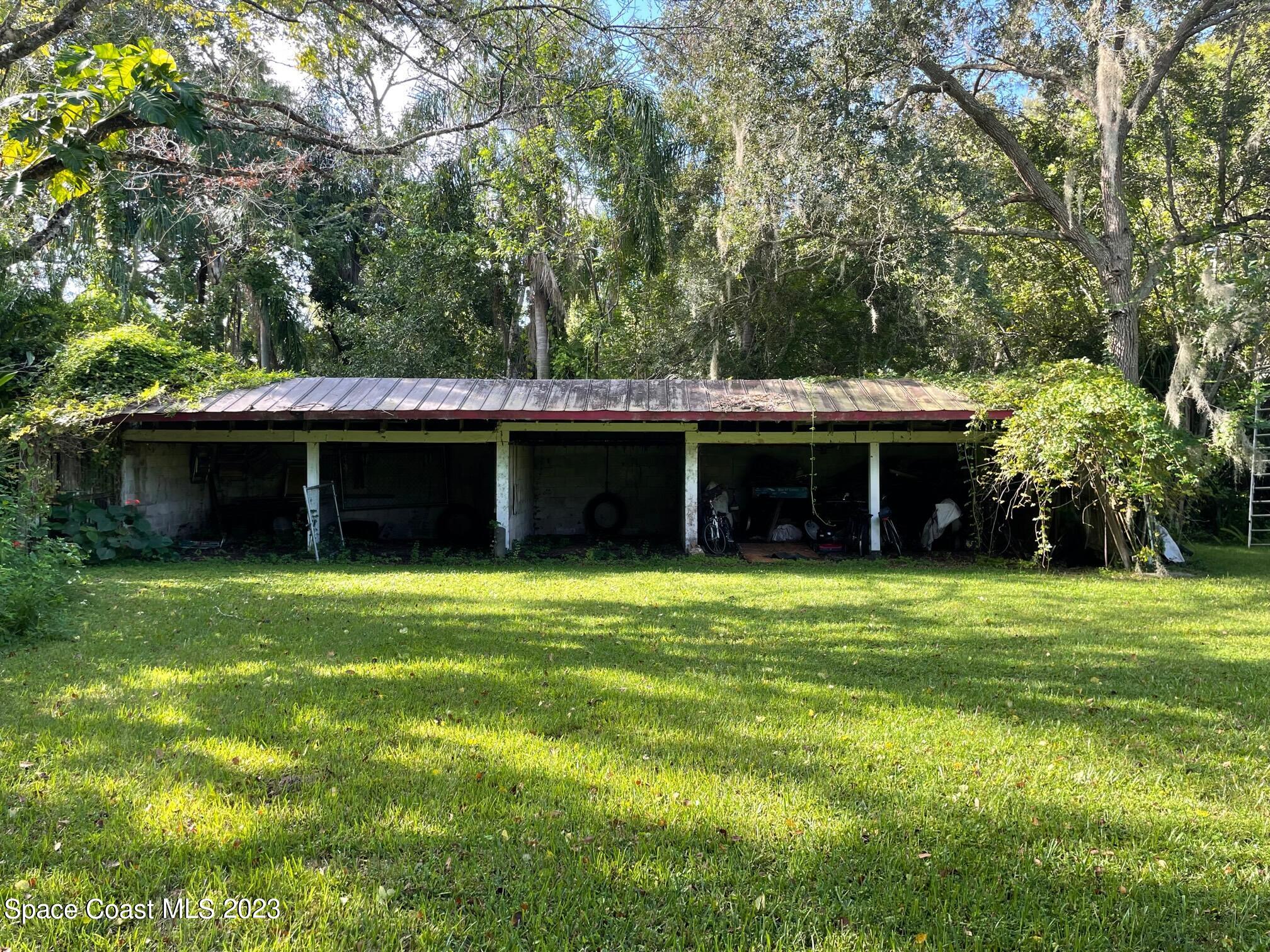 3395 Turtle Mound Road Melbourne, FL 32934 - Photo 10 of 48 a front view of a house with a garden