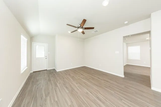 wooden floor in an empty room with a window