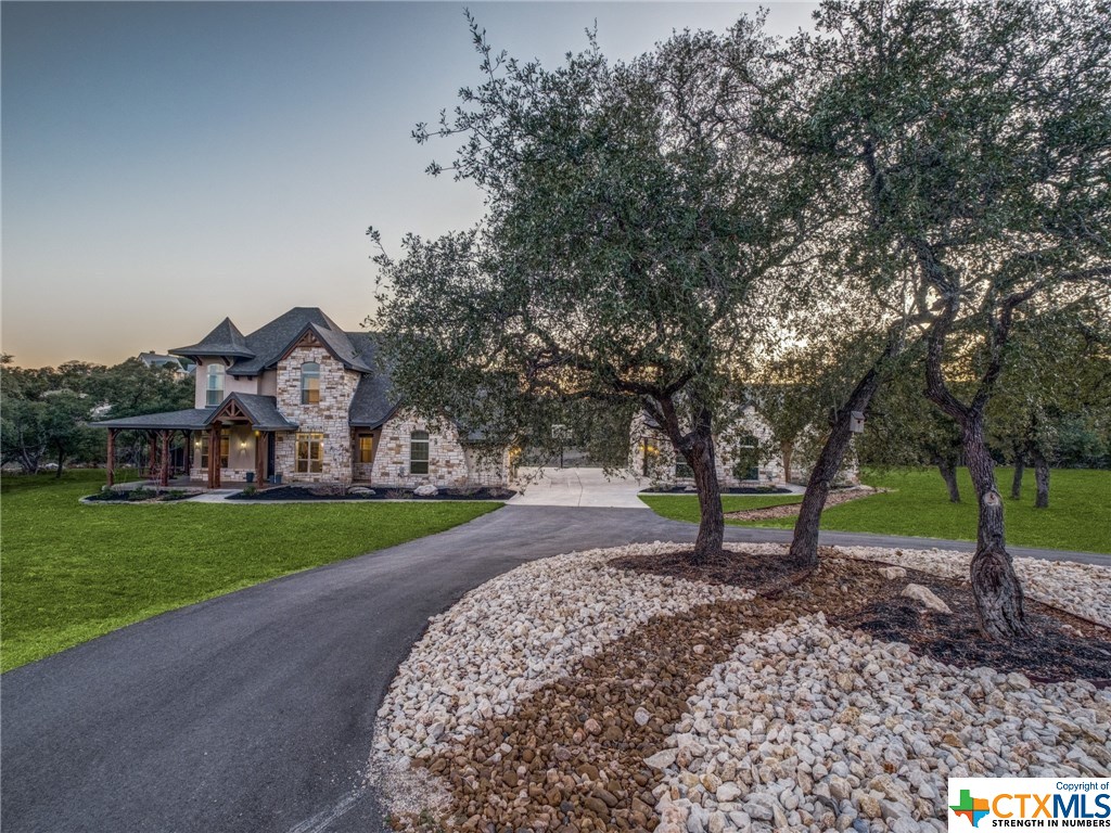 a view of a house with a yard and tree s