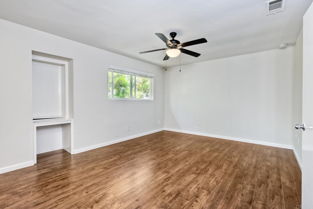 2425-27 Torrejon Place Carlsbad, CA 92009 - Photo 12 of 59 a view of empty room with wooden floor and fan
