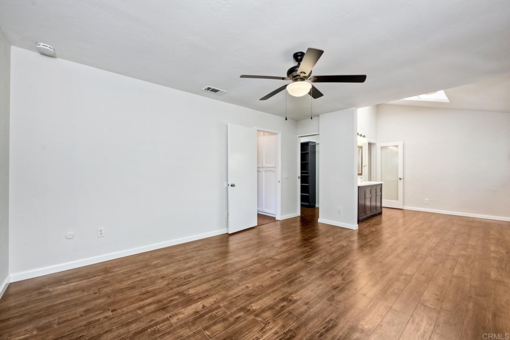 2425-27 Torrejon Place Carlsbad, CA 92009 - Photo 13 of 59 a view of an empty room with wooden floor and a ceiling fan