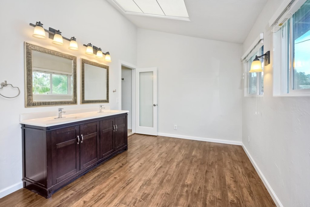 2425-27 Torrejon Place Carlsbad, CA 92009 - Photo 14 of 59 a bathroom with a sink mirror and a window