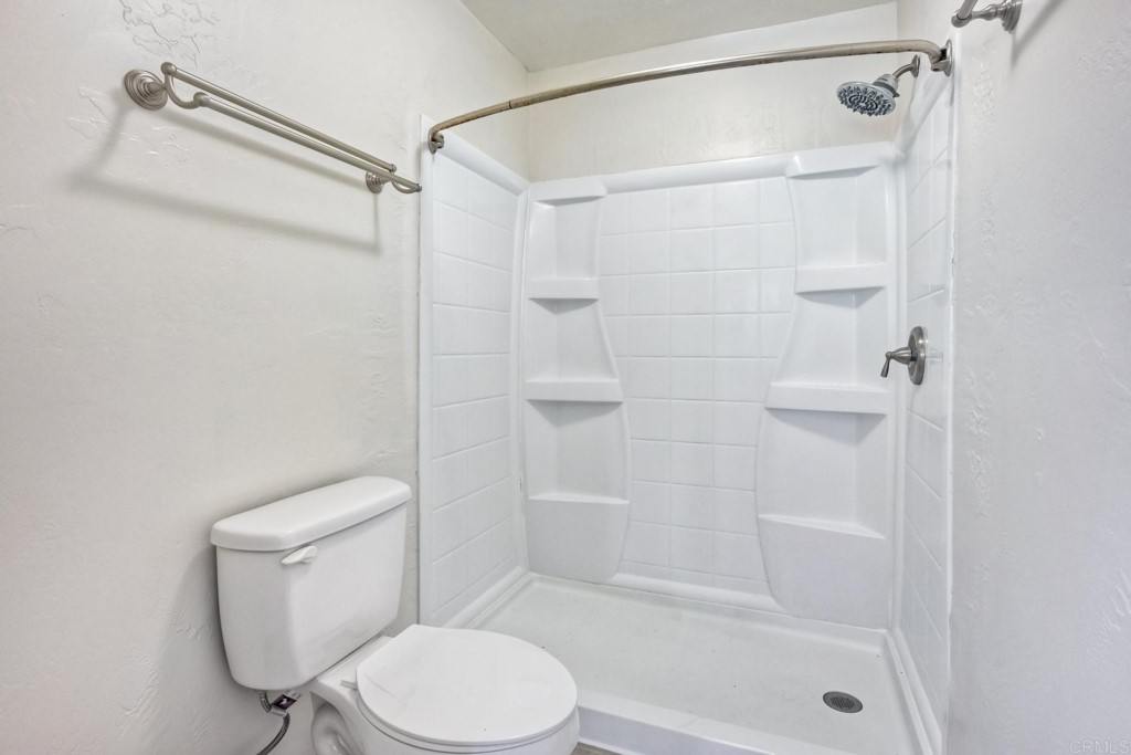 2425-27 Torrejon Place Carlsbad, CA 92009 - Photo 15 of 59 a white toilet and shower