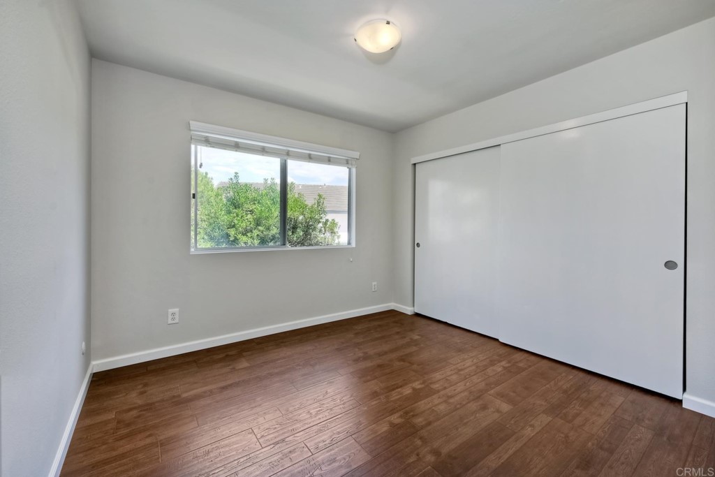 2425-27 Torrejon Place Carlsbad, CA 92009 - Photo 16 of 59 an empty room with wooden floor and windows