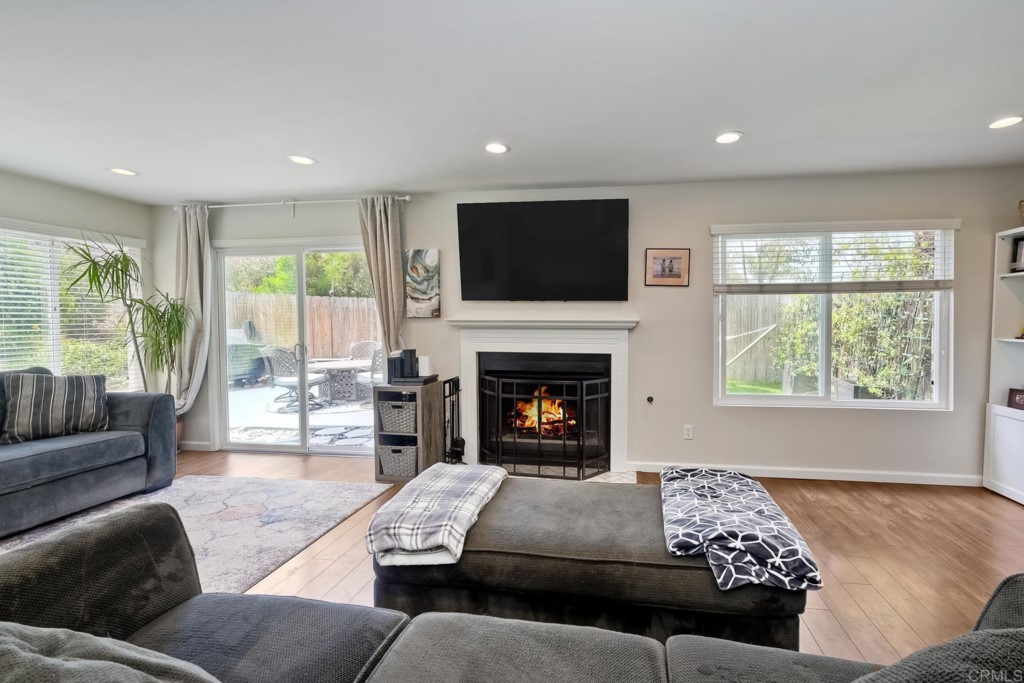 2425-27 Torrejon Place Carlsbad, CA 92009 - Photo 28 of 59 a living room with furniture window and a fireplace