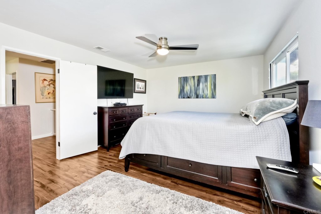 2425-27 Torrejon Place Carlsbad, CA 92009 - Photo 39 of 59 a spacious bedroom with a bed and a flat screen tv