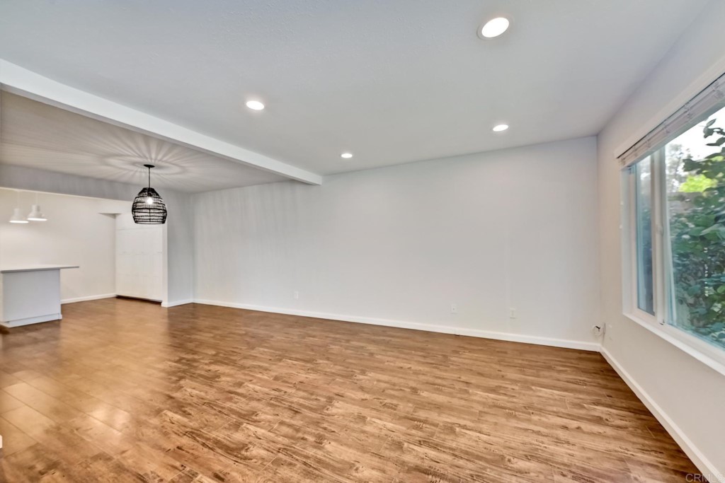 2425-27 Torrejon Place Carlsbad, CA 92009 - Photo 6 of 59 an empty room with wooden floor and windows