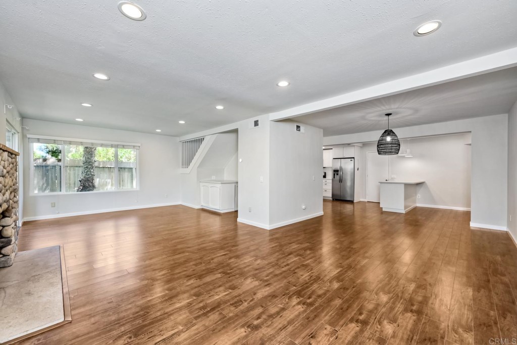 2425-27 Torrejon Place Carlsbad, CA 92009 - Photo 7 of 59 a view of empty room with wooden floor and windows
