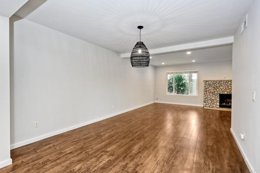 2425-27 Torrejon Place Carlsbad, CA 92009 - Photo 10 of 59 a view of an empty room with wooden floor and a window