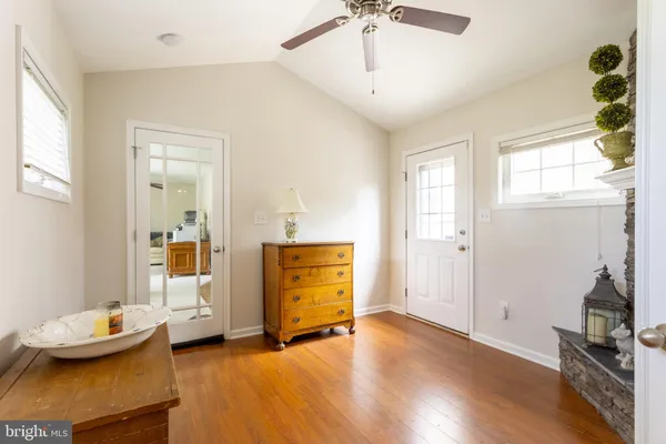 a kitchen with stainless steel appliances granite countertop a refrigerator a stove top oven a sink dishwasher and wooden cabinets with large windows