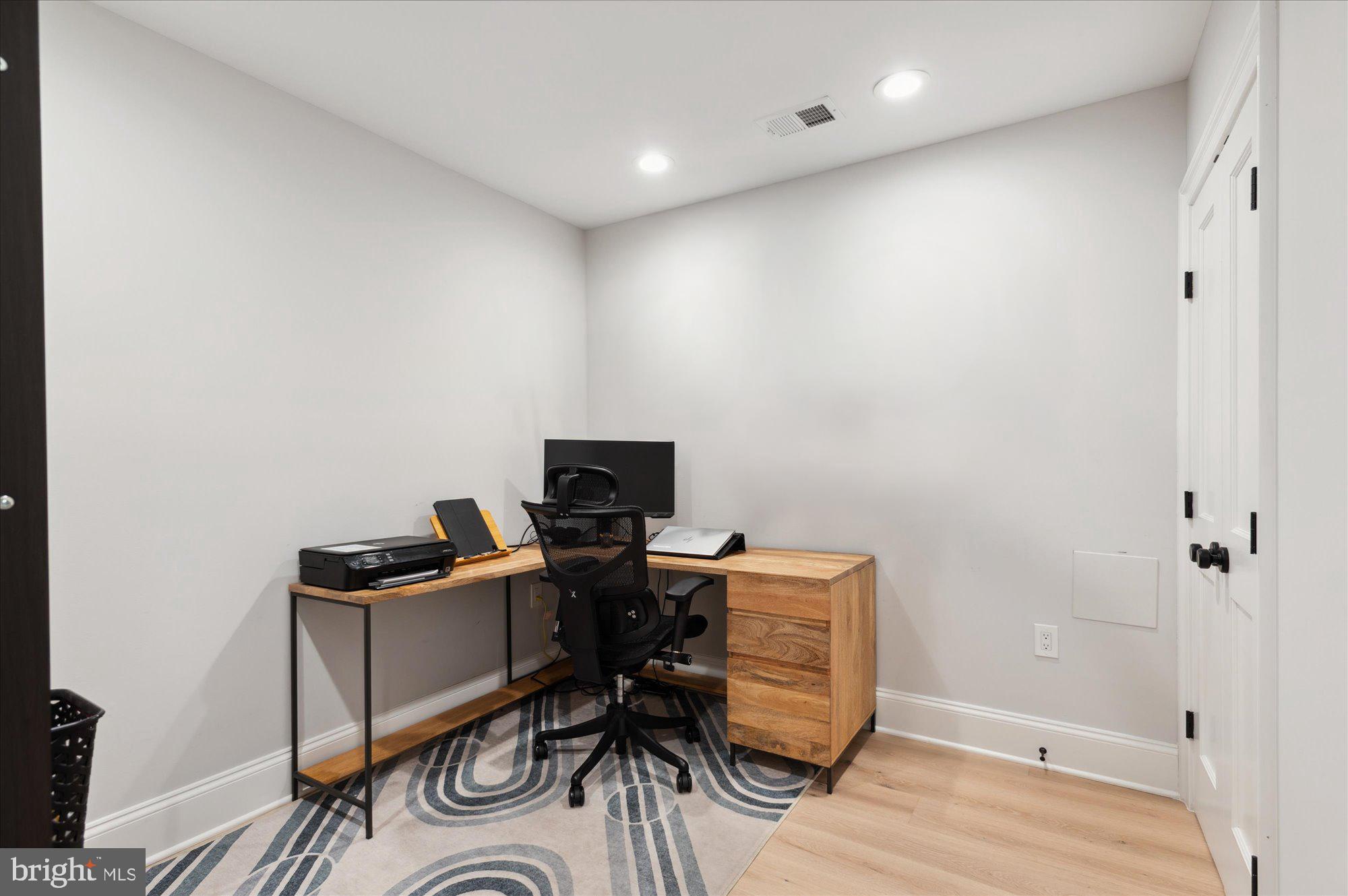 2150 Florida Avenue Northwest, Unit 1 Washington, DC 20008 - Photo 14 of 23 a view of a workspace with furniture and wooden floor