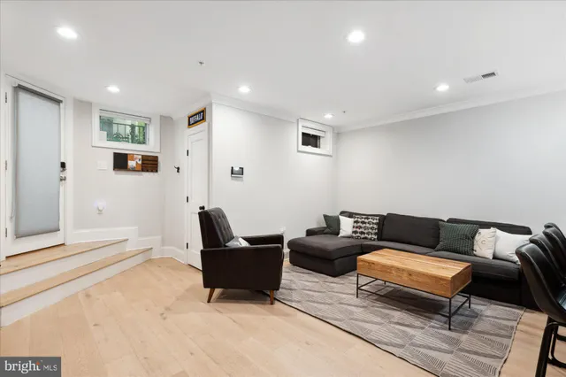 a living room with furniture and a rug