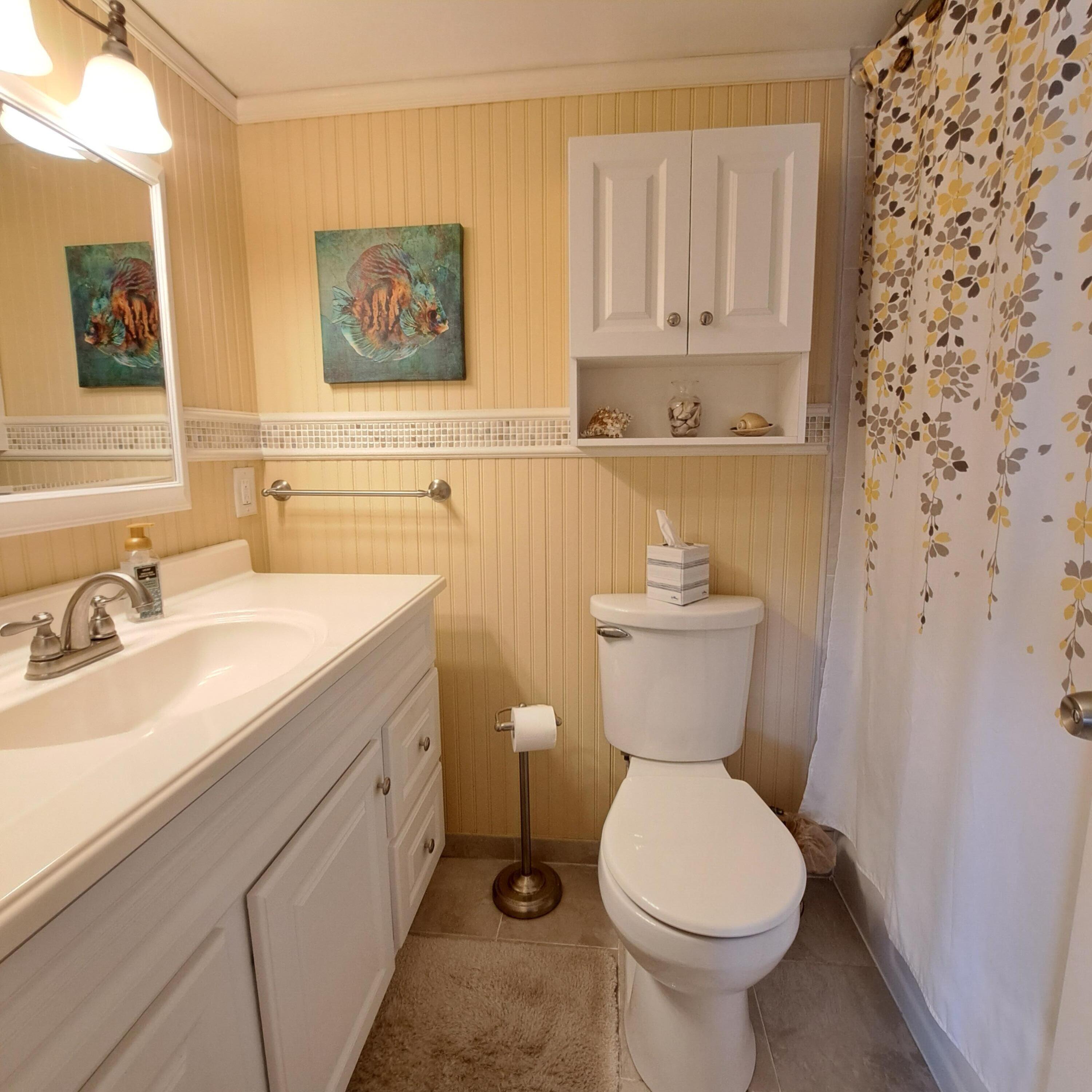 53 Northampton C West Palm Beach, FL 33417 - Photo 18 of 27 a bathroom with a toilet sink and mirror