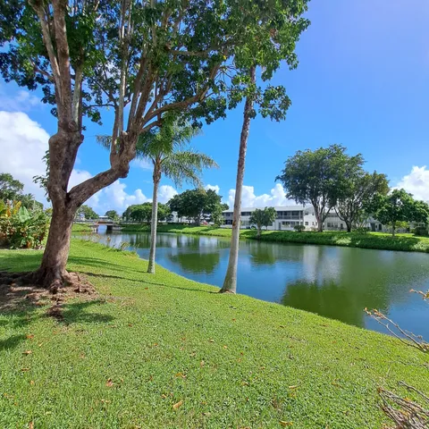 a view of a lake with a house in the background