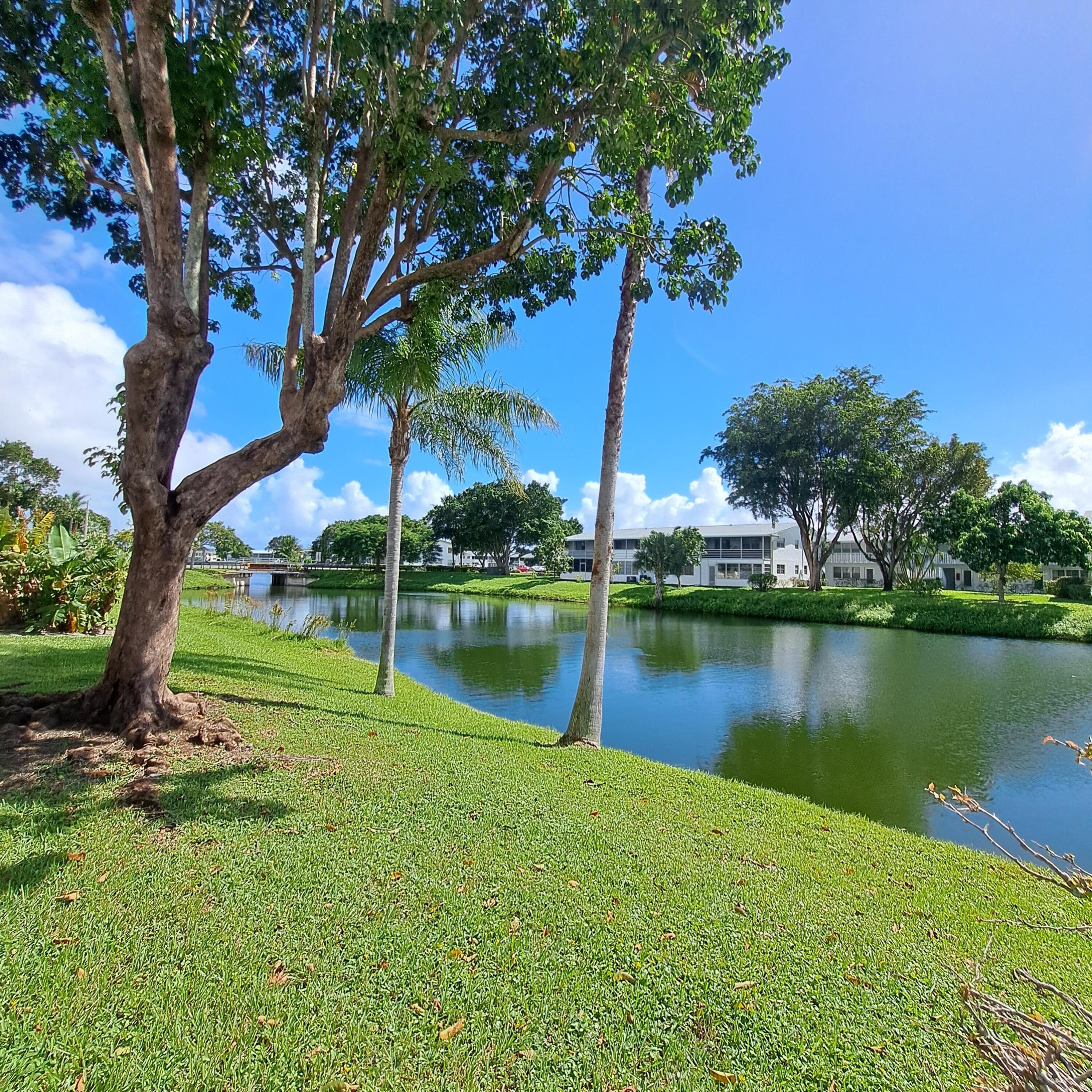 53 Northampton C West Palm Beach, FL 33417 - Photo 21 of 27 a view of a lake with a house in the background