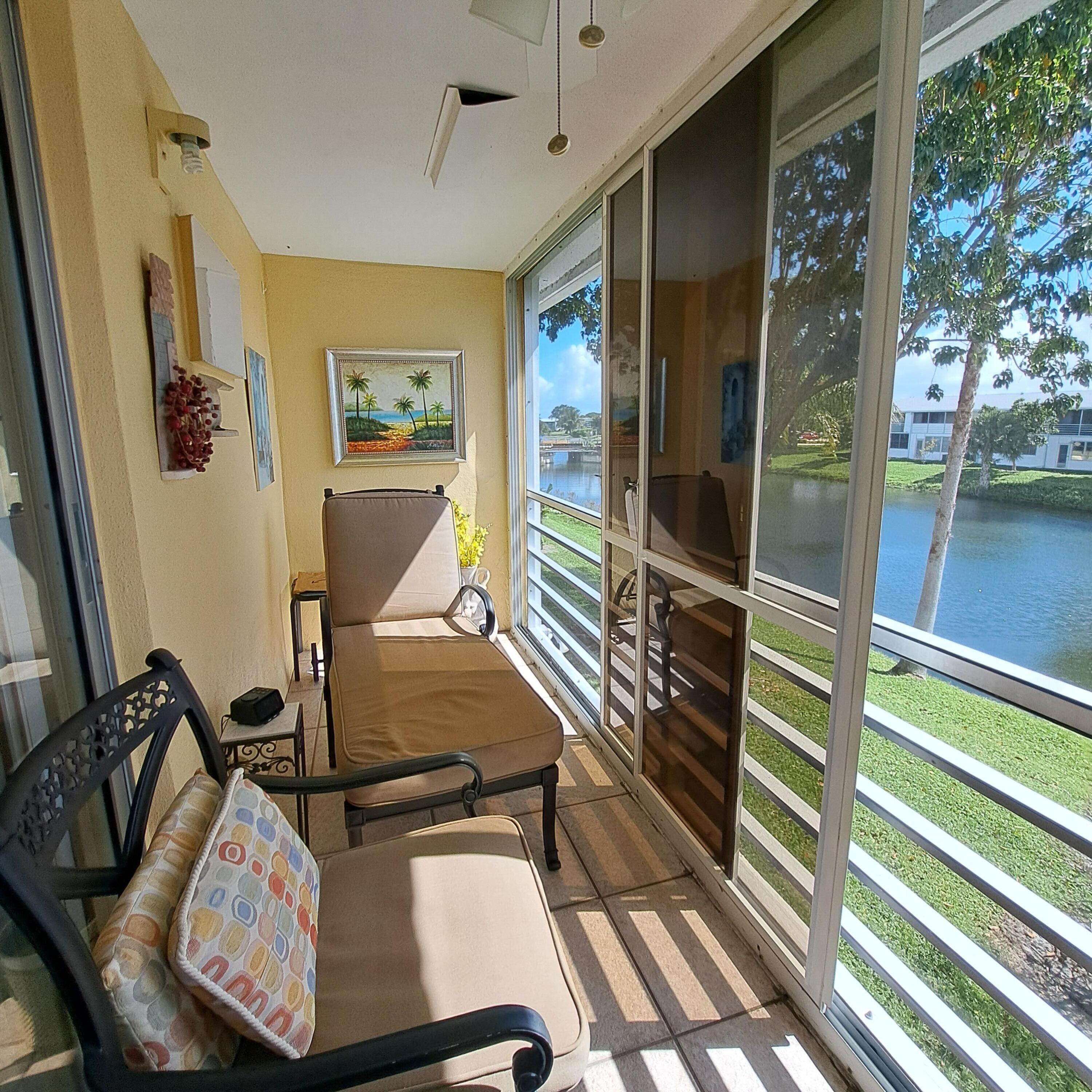 53 Northampton C West Palm Beach, FL 33417 - Photo 24 of 27 a view of a balcony with furniture and a table