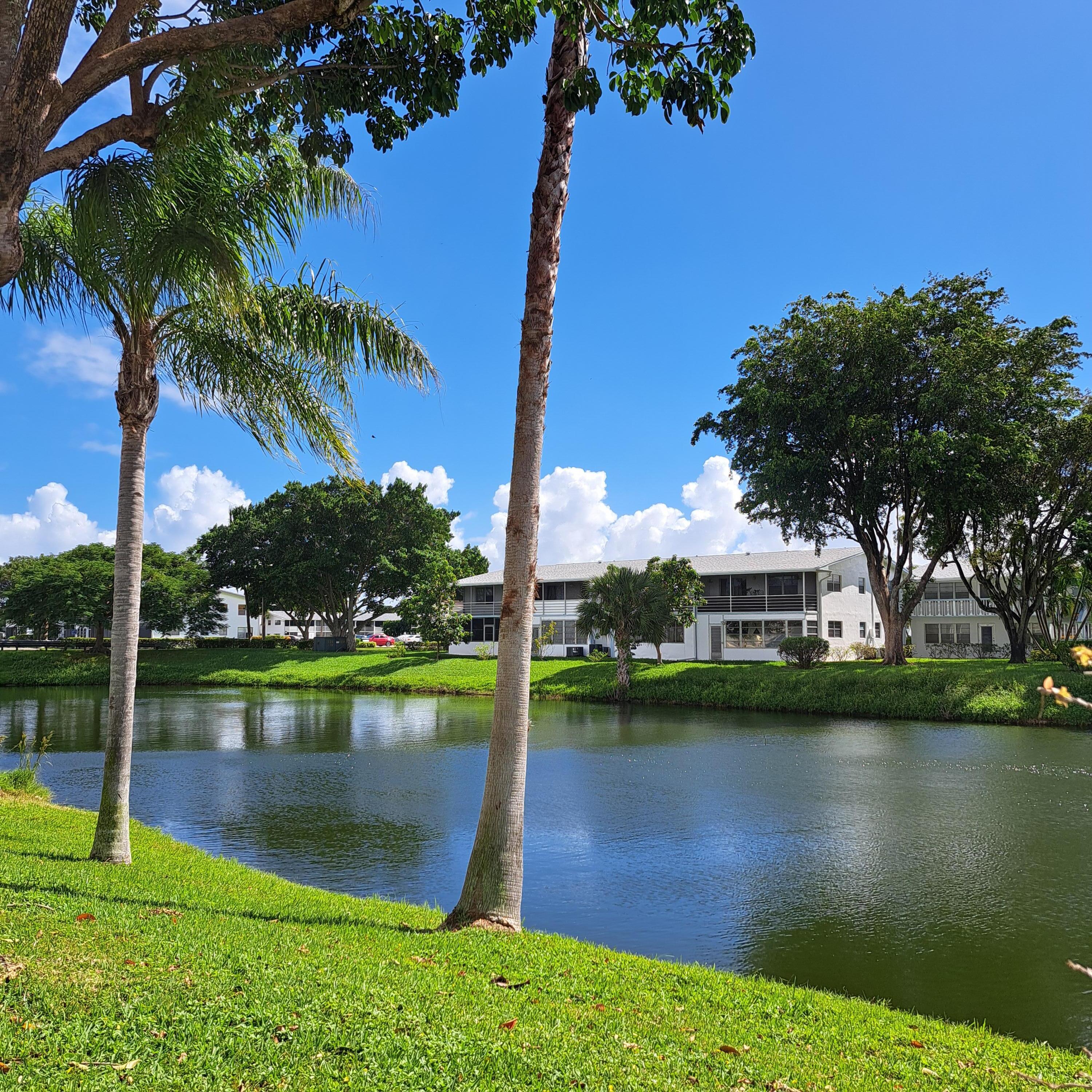 53 Northampton C West Palm Beach, FL 33417 - Photo 3 of 27 a view of a lake with a house in the background