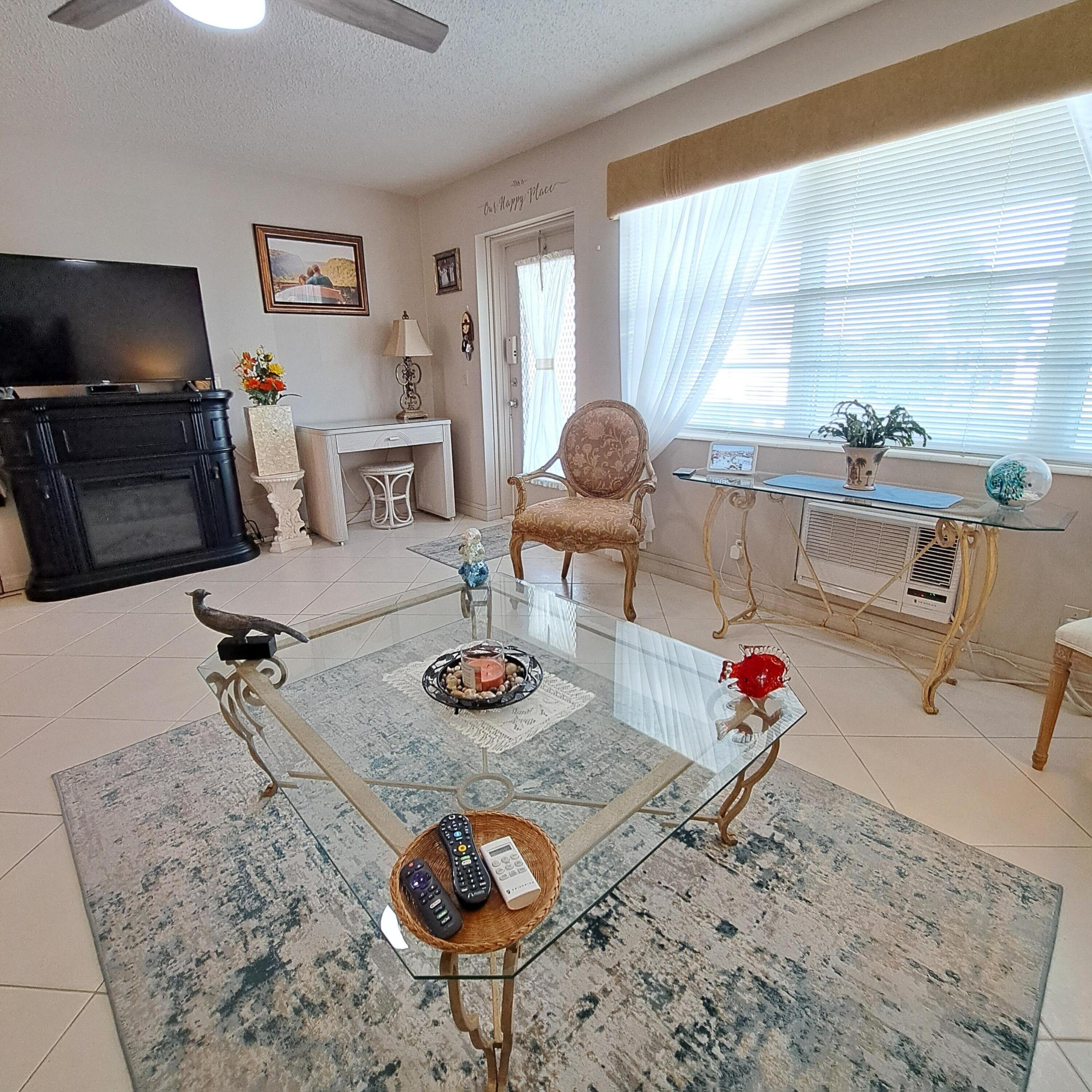 53 Northampton C West Palm Beach, FL 33417 - Photo 5 of 27 a living room with furniture and a flat screen tv