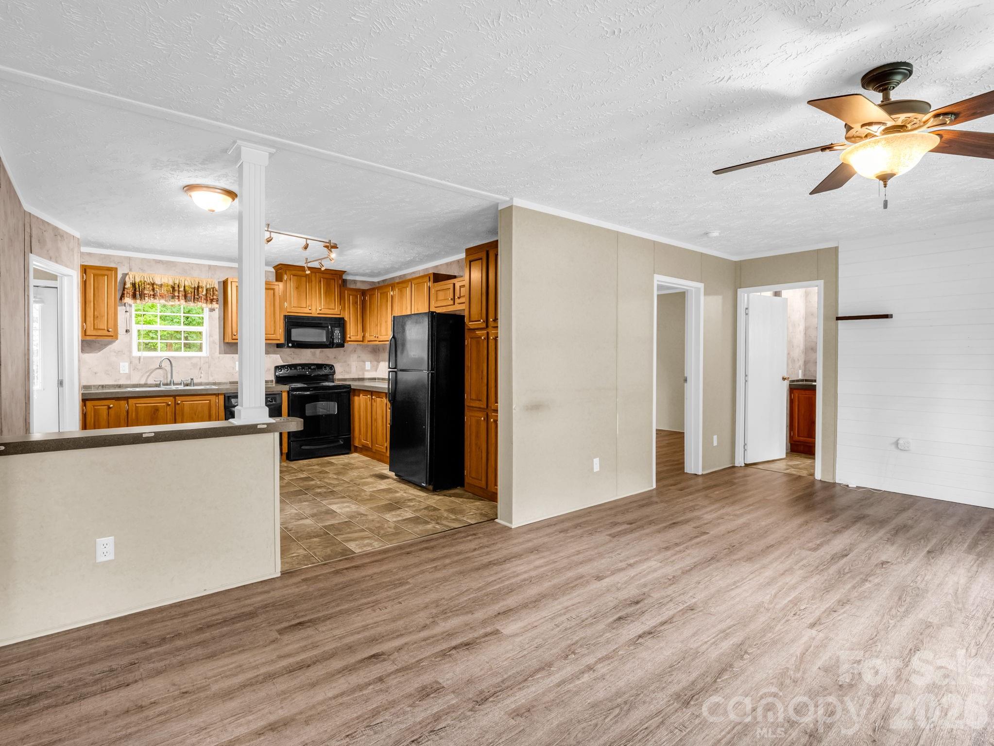 1449 Toney Road Bostic, NC 28018 - Photo 16 of 43 a view of a kitchen with furniture a refrigerator and wooden floor