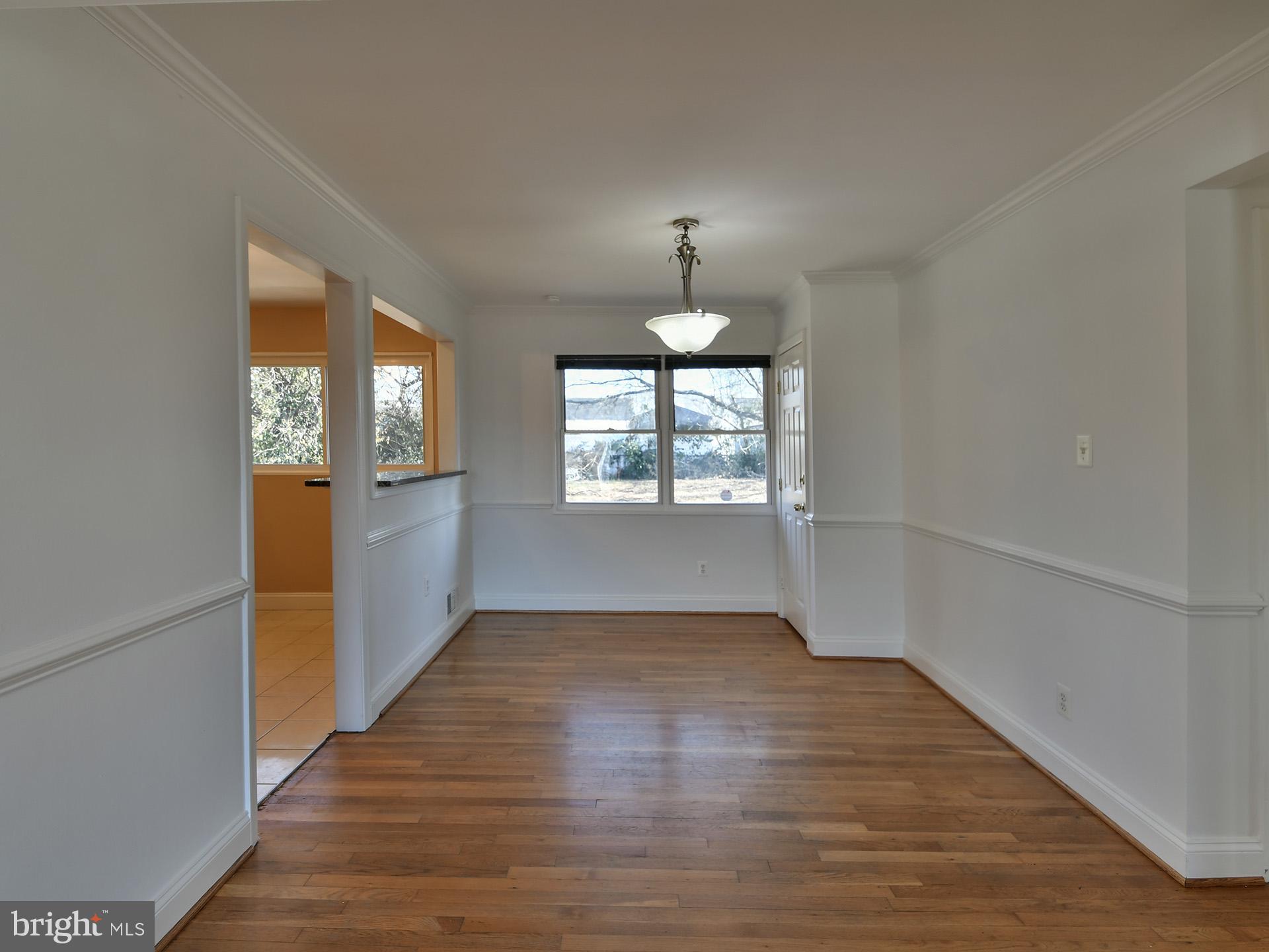 2308 Senator Avenue District Heights, MD 20747 - Photo 17 of 66 an empty room with wooden floor mirror and windows