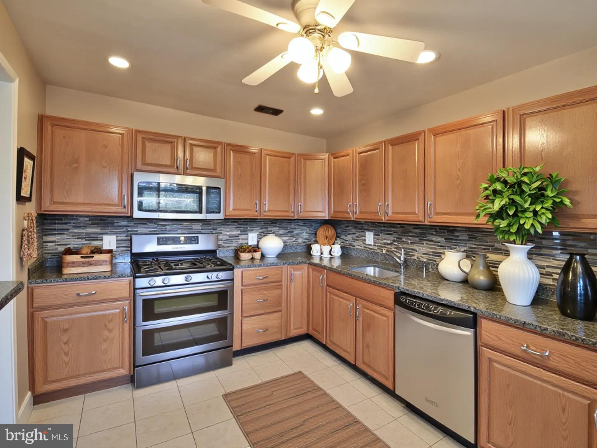 2308 Senator Avenue District Heights, MD 20747 - Photo 22 of 66 a kitchen with stainless steel appliances granite countertop a sink and cabinets