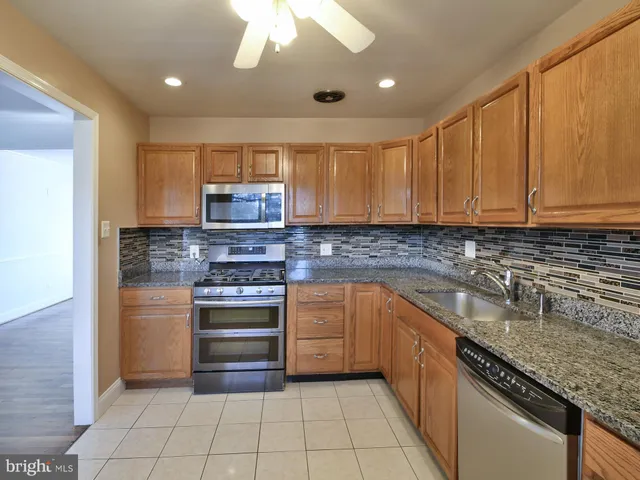 a stove sitting inside of a kitchen with granite countertop
