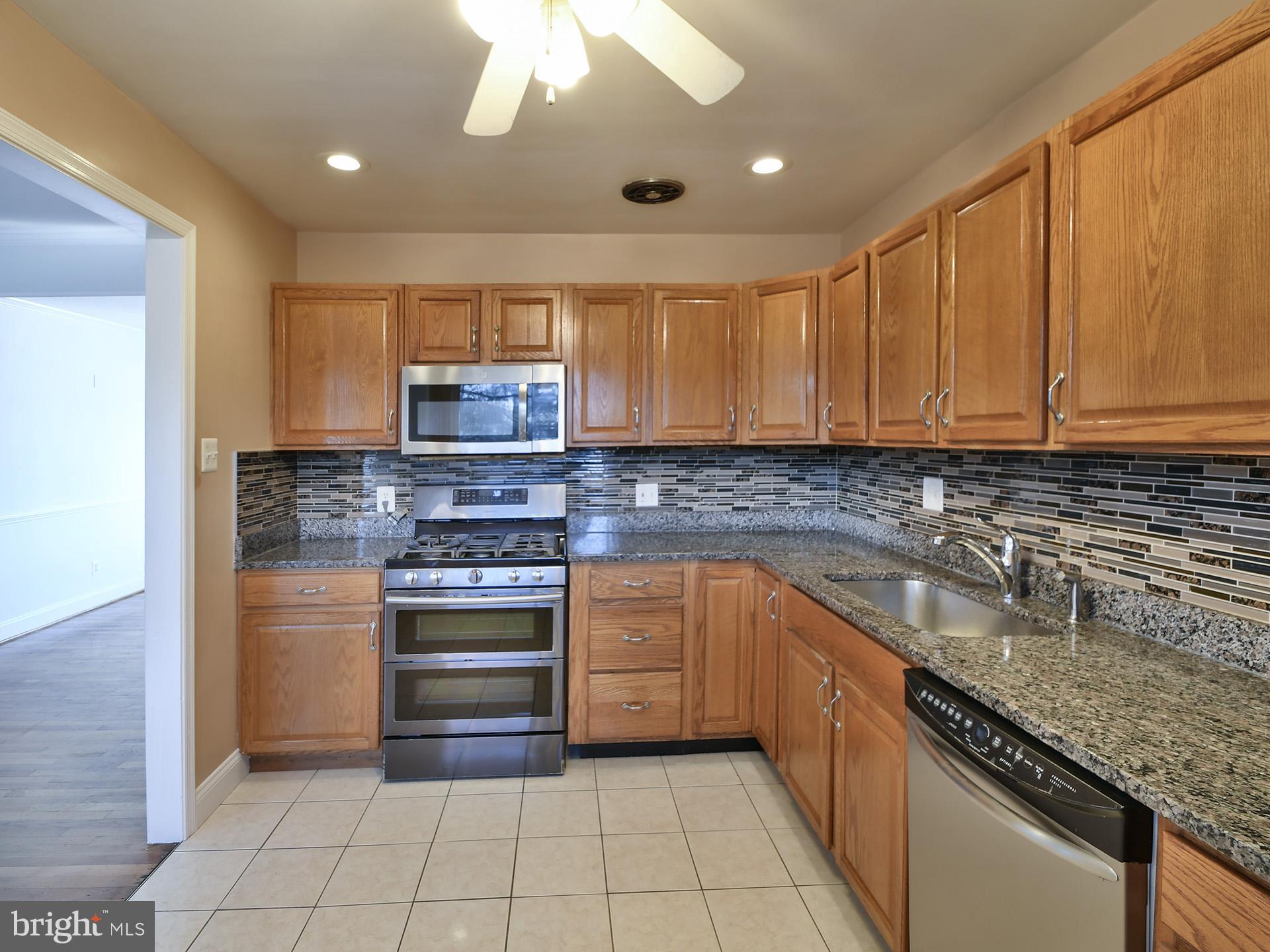2308 Senator Avenue District Heights, MD 20747 - Photo 23 of 66 a kitchen with stainless steel appliances granite countertop a sink and a stove