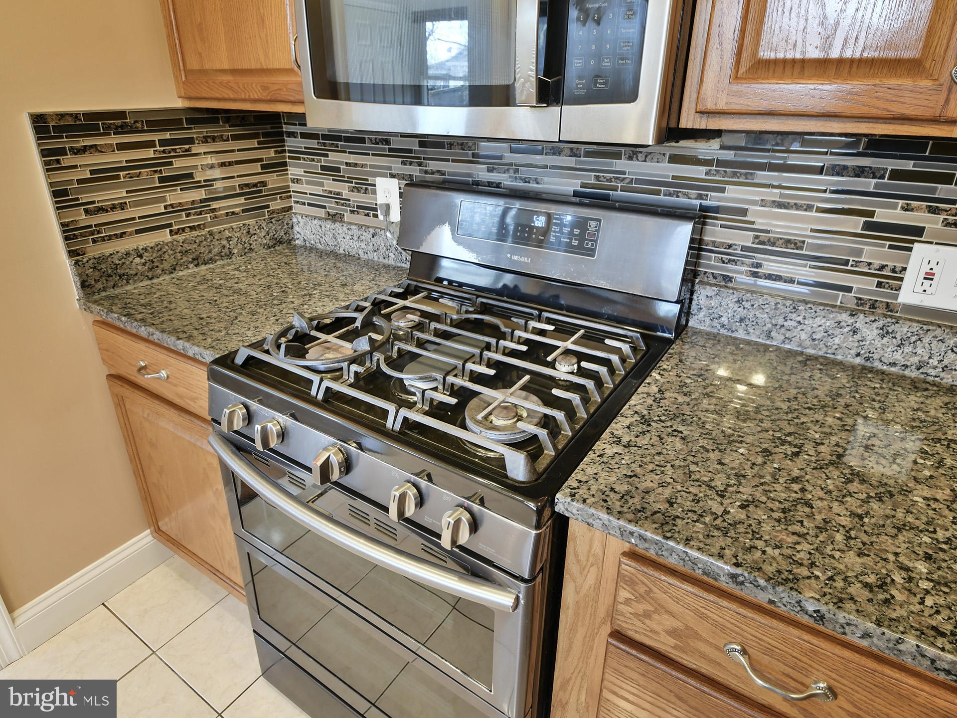 2308 Senator Avenue District Heights, MD 20747 - Photo 26 of 66 a stove sitting inside of a kitchen with granite countertop