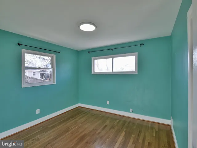 a bathroom with a sink a toilet a mirror and shower
