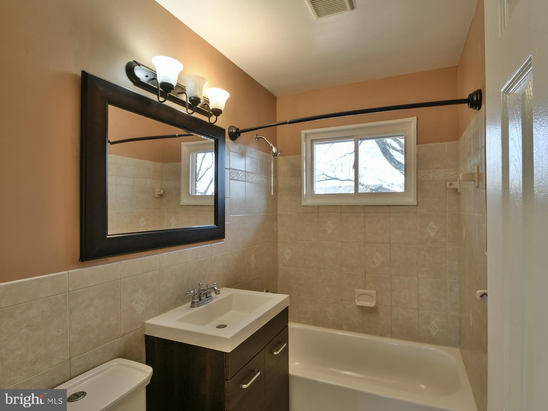 2308 Senator Avenue District Heights, MD 20747 - Photo 31 of 66 a bathroom with a sink a toilet a mirror and shower
