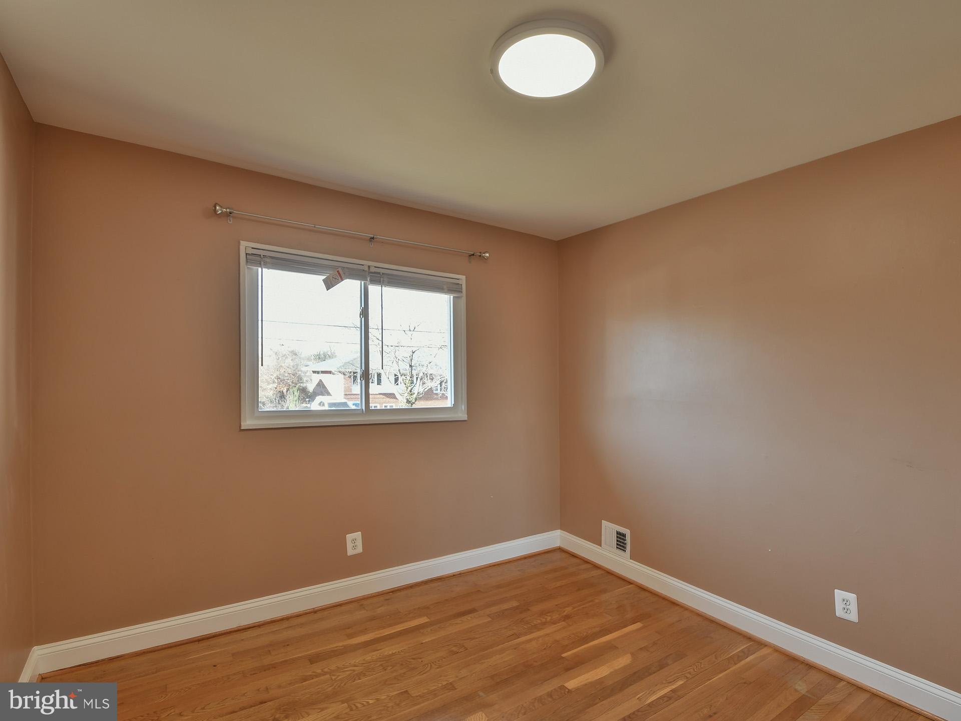2308 Senator Avenue District Heights, MD 20747 - Photo 35 of 66 an empty room with wooden floor and windows