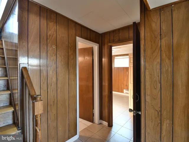 an empty room with closet and a chandelier fan