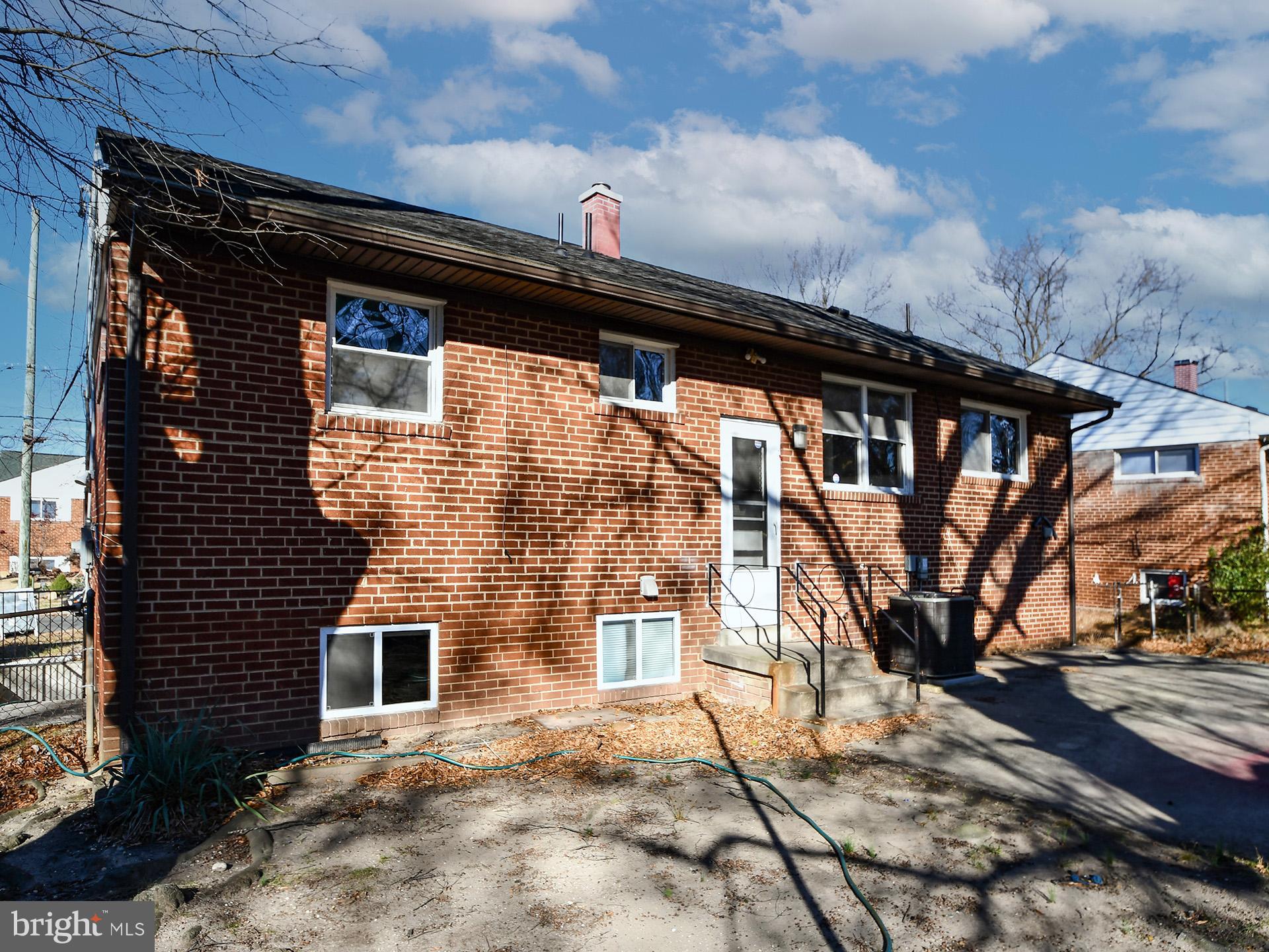 2308 Senator Avenue District Heights, MD 20747 - Photo 5 of 66 a black and white building with trees in front of it