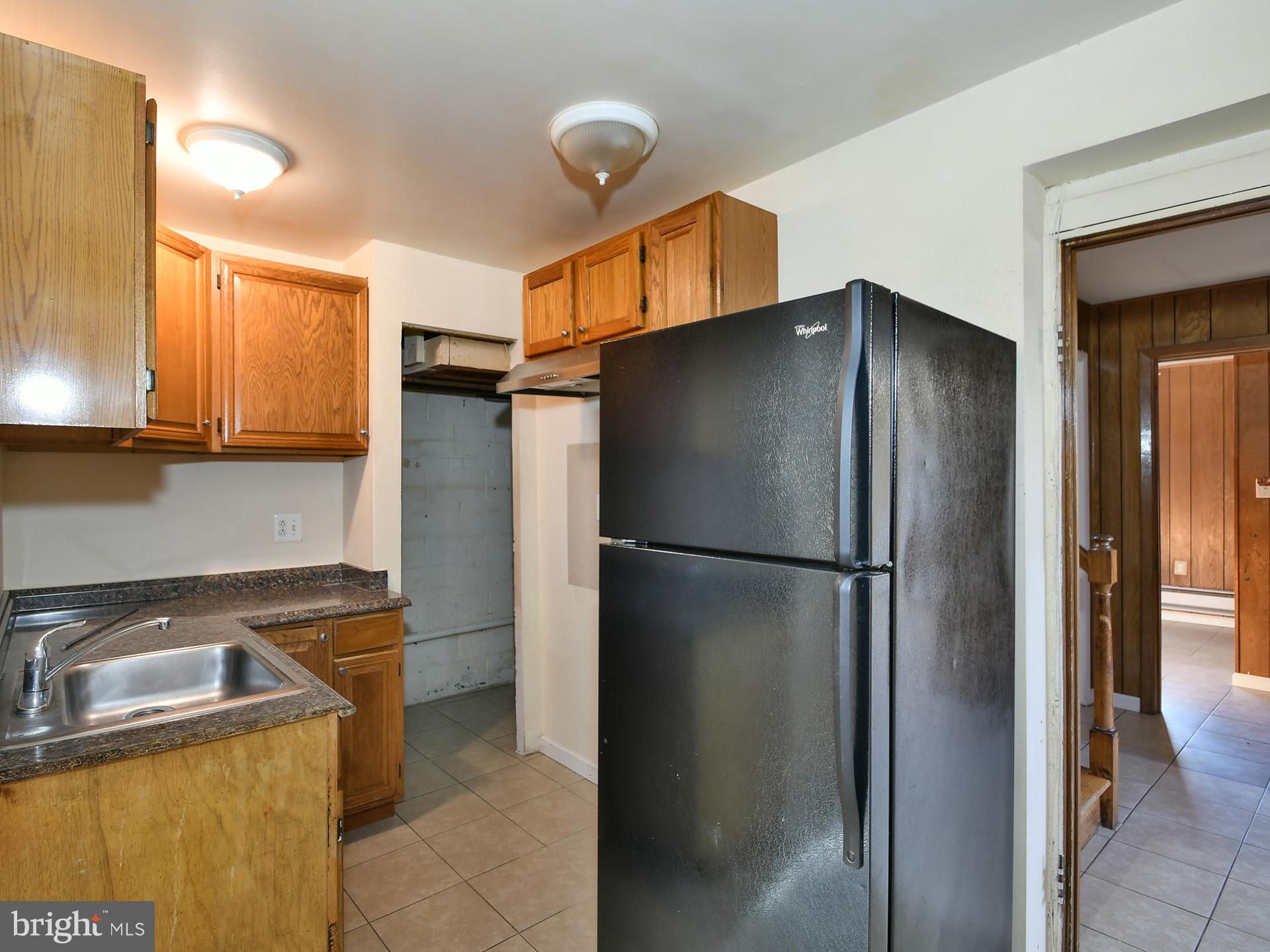 2308 Senator Avenue District Heights, MD 20747 - Photo 51 of 66 a metallic refrigerator freezer sitting in a kitchen