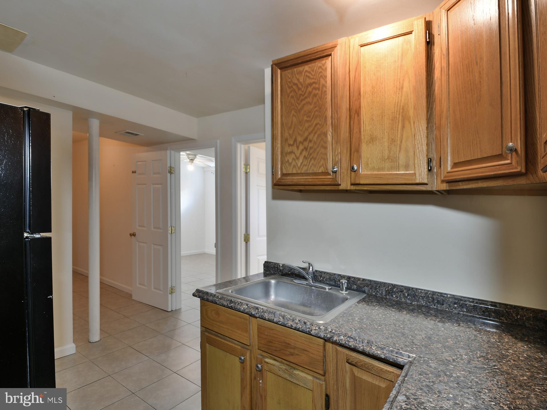 2308 Senator Avenue District Heights, MD 20747 - Photo 53 of 66 a bathroom with a granite countertop sink and a mirror