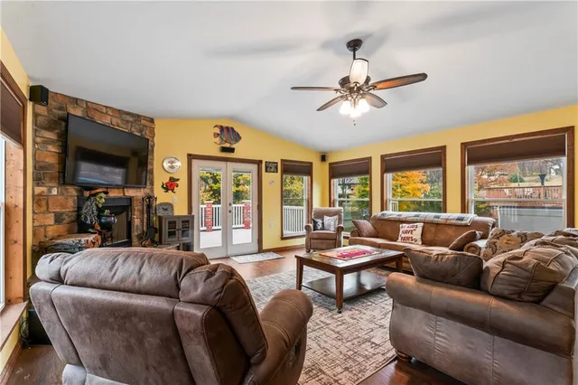 a living room with furniture ceiling fan and a window
