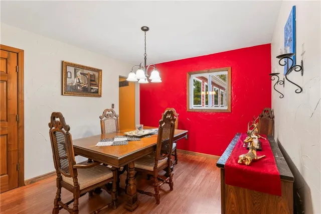 a view of a dining room with furniture and chandelier