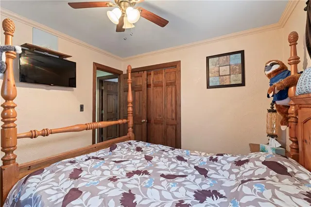 a bedroom with a bed and a flat screen tv